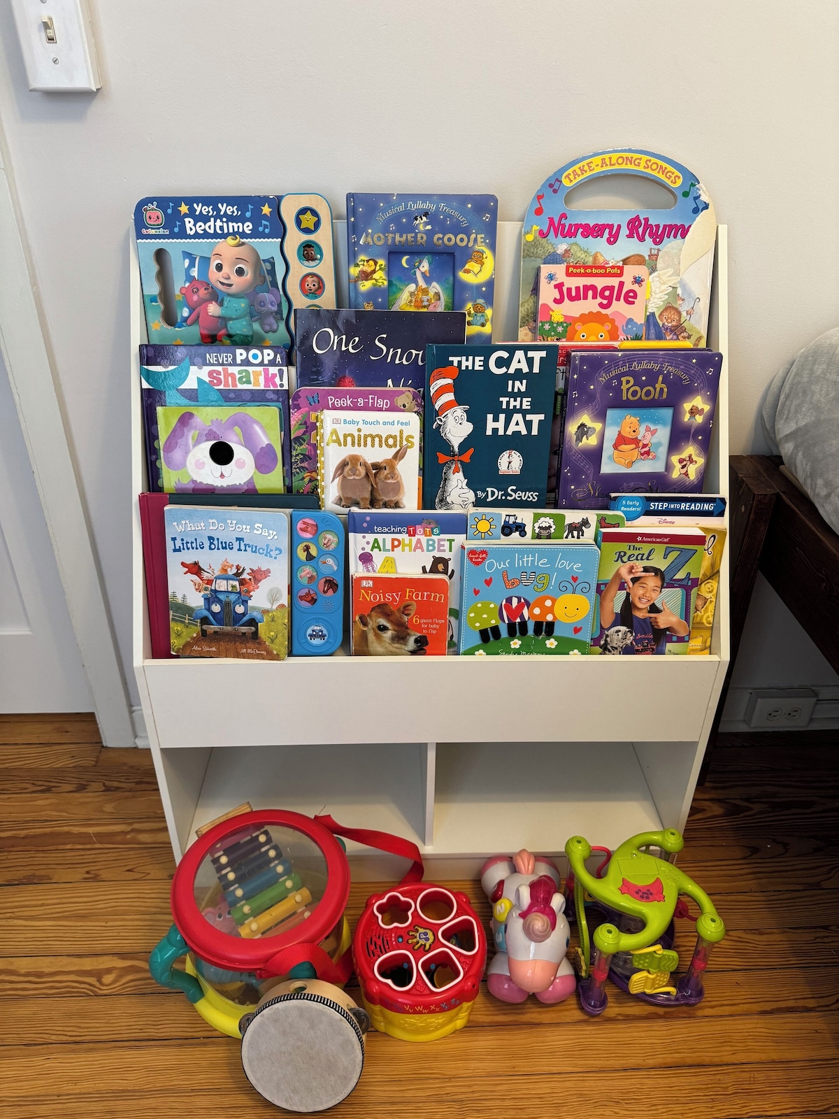 A bookshelf filled with children's books and toys.