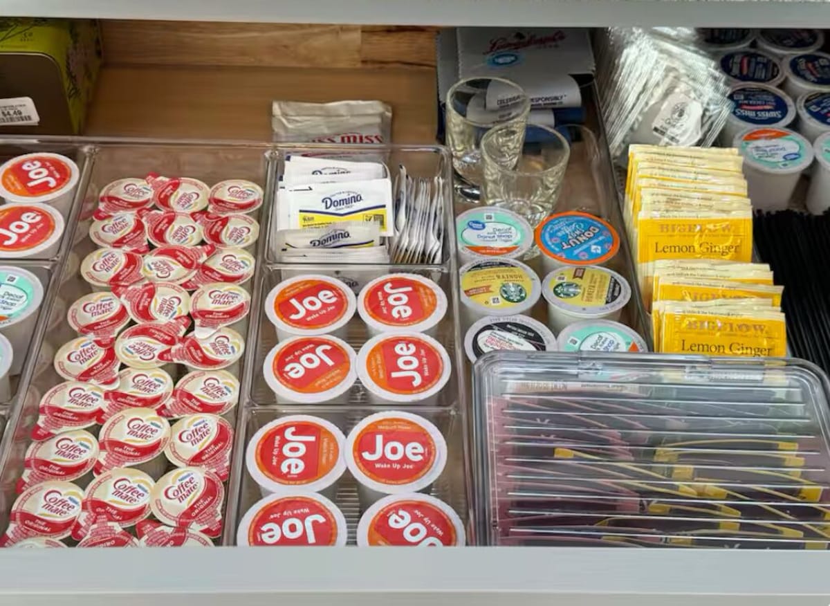 A variety of packaged food items, including coffee, yogurt, and lemon ginger products, displayed in a refrigerated section.